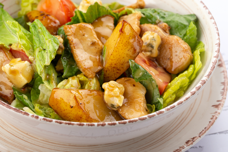 Pear walnut grilled chicken on a bed of green lettuce 